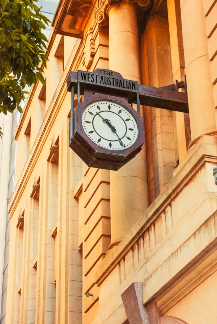 A classic clock on a historic building facade in Perth, WA, Australia.